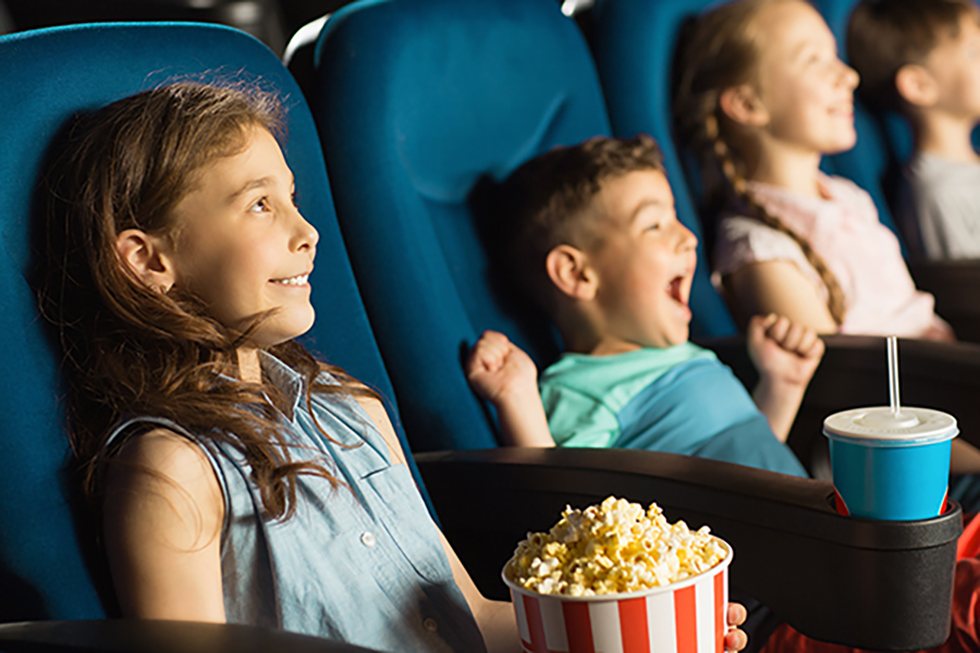 Cute little kids smiling joyfully watching a movie at the cinema entertainment childhood kids comedy cartoons family recreation leisure activity holidays positivity emotions concept